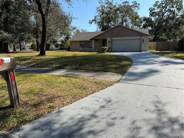 ranch-style home featuring a front lawn and a garage