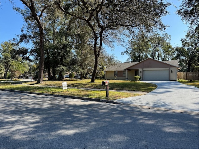 ranch-style home with a garage and a front yard