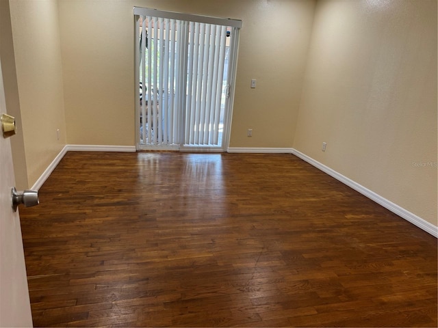 empty room with dark hardwood / wood-style floors