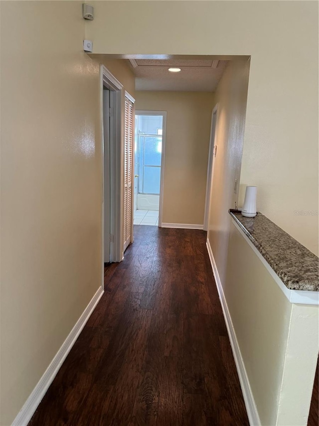 corridor with dark hardwood / wood-style floors