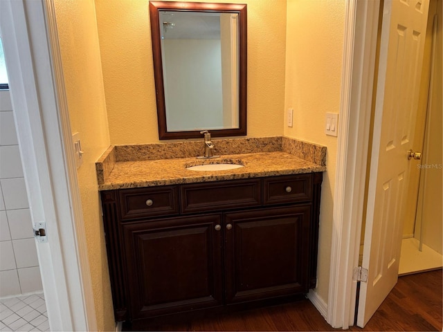 bathroom with hardwood / wood-style floors and vanity