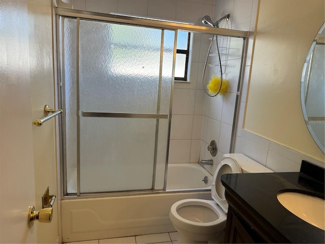 full bathroom featuring toilet, tile patterned flooring, enclosed tub / shower combo, and vanity