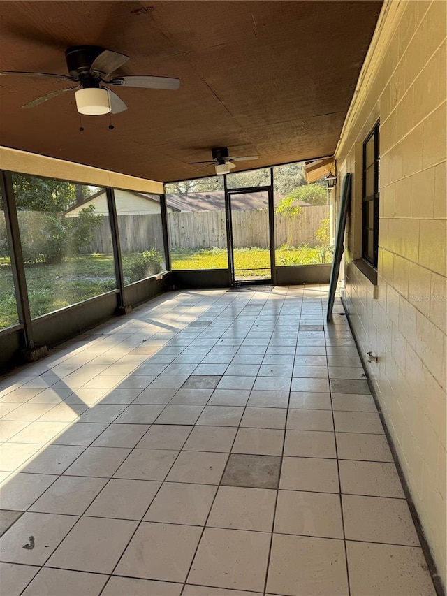 unfurnished sunroom with ceiling fan and wood ceiling