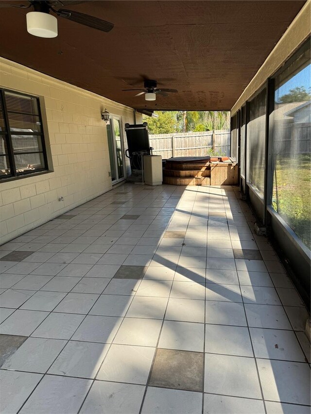 view of patio / terrace with ceiling fan and a hot tub