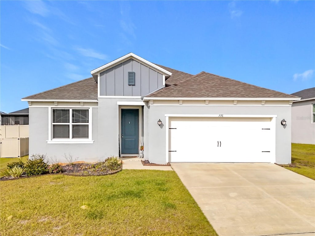 view of front facade featuring a garage and a front lawn