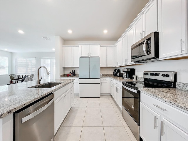 kitchen featuring white cabinets, appliances with stainless steel finishes, and sink