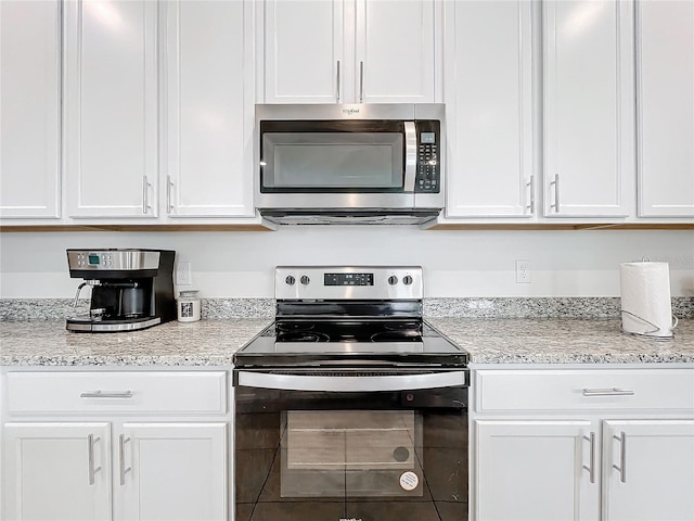 kitchen featuring white cabinets and appliances with stainless steel finishes