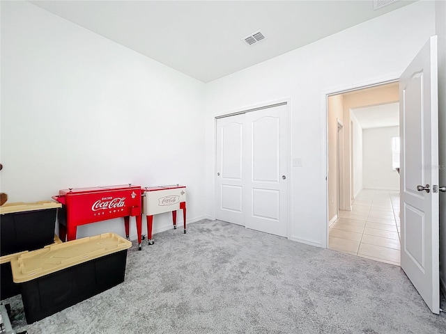 recreation room with light carpet