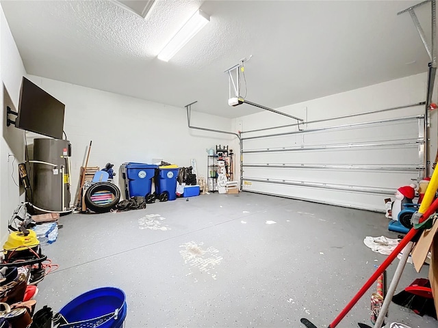 garage with electric water heater and a garage door opener