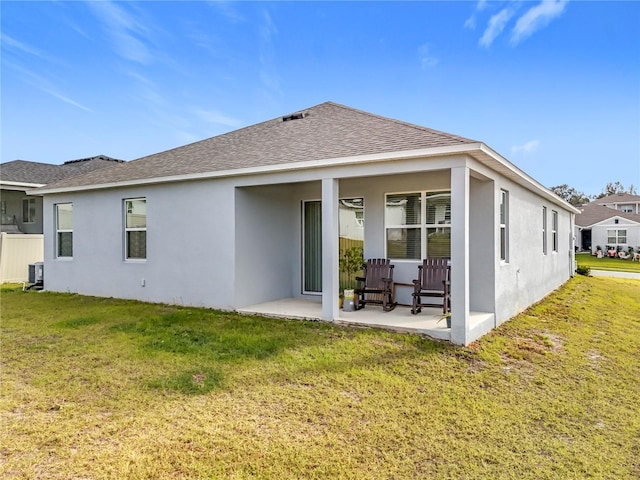 back of property featuring a yard, cooling unit, and a patio