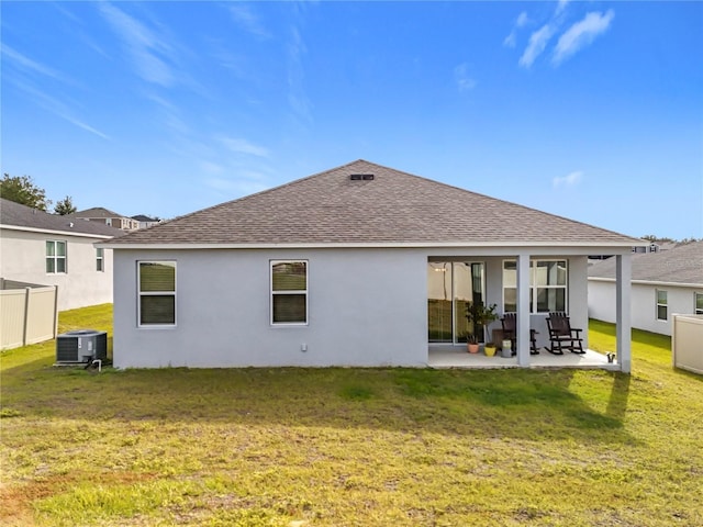 back of property featuring a patio, a lawn, and central air condition unit