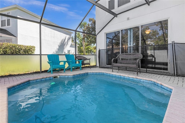 view of swimming pool with a lanai and a patio