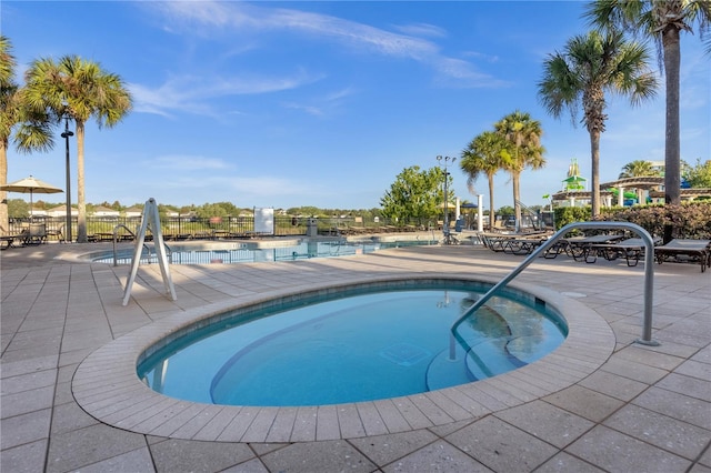 view of pool featuring a patio area and a community hot tub