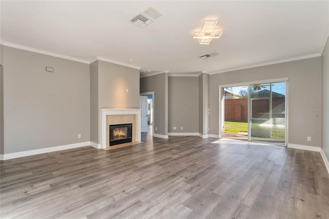 unfurnished living room with ornamental molding and wood-type flooring