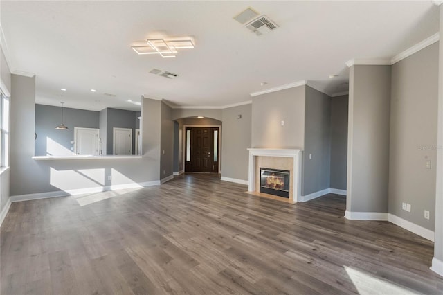 unfurnished living room featuring ornamental molding and hardwood / wood-style floors