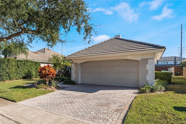 view of front facade with a garage and a front yard