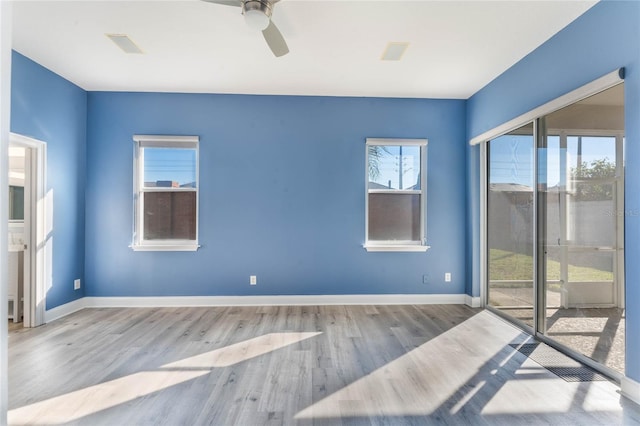 empty room featuring ceiling fan and light hardwood / wood-style flooring