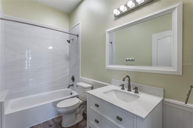 full bathroom featuring vanity, toilet, tiled shower / bath combo, and wood-type flooring