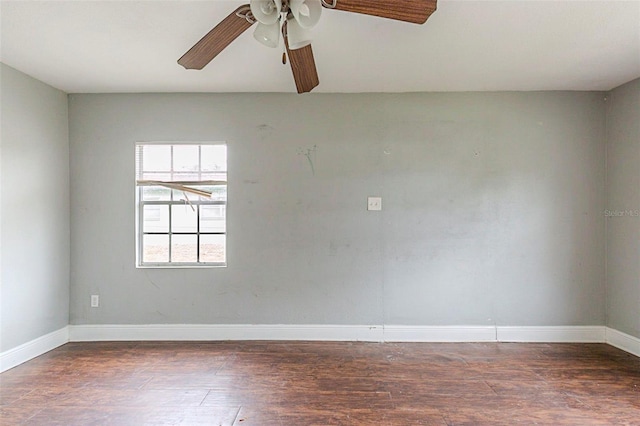 unfurnished room featuring dark wood-type flooring and ceiling fan