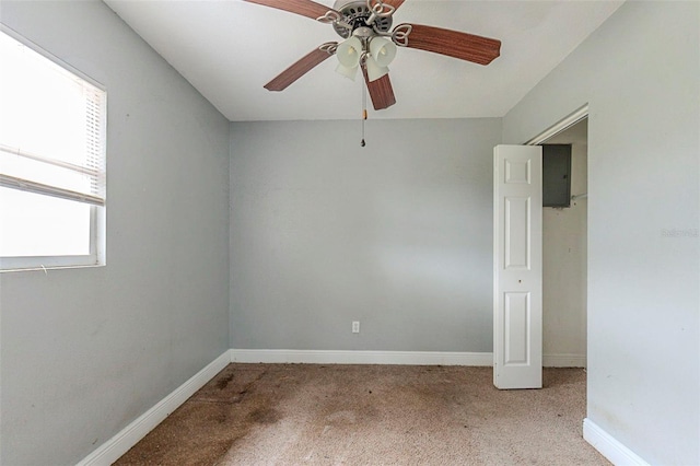 carpeted spare room with ceiling fan