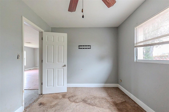 unfurnished room featuring ceiling fan and light carpet