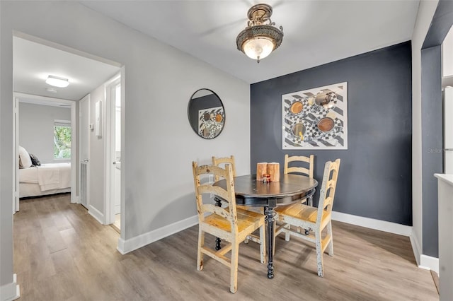 dining space featuring light wood-type flooring