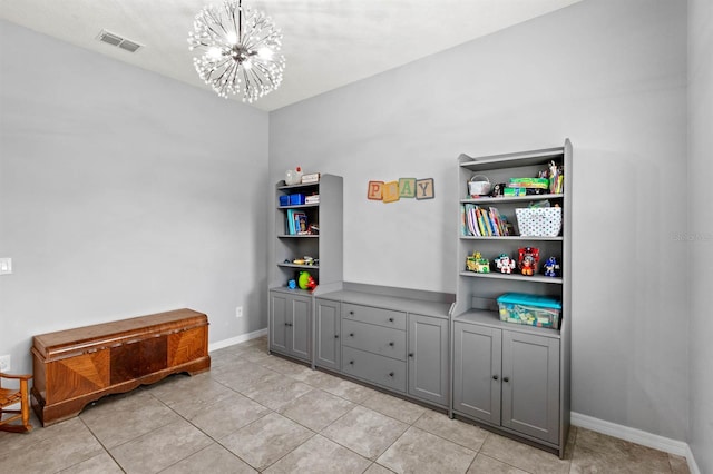 rec room featuring light tile patterned floors and a chandelier