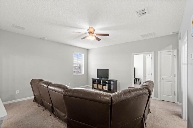 carpeted living room with ceiling fan and a textured ceiling