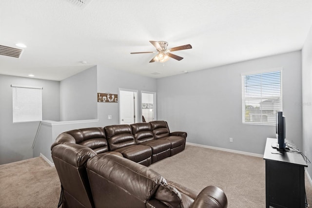 carpeted living room featuring ceiling fan