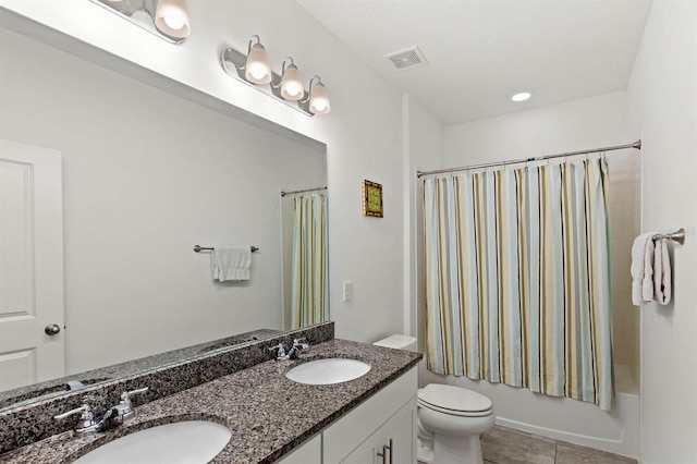 full bathroom featuring tile patterned floors, toilet, vanity, and shower / bath combo