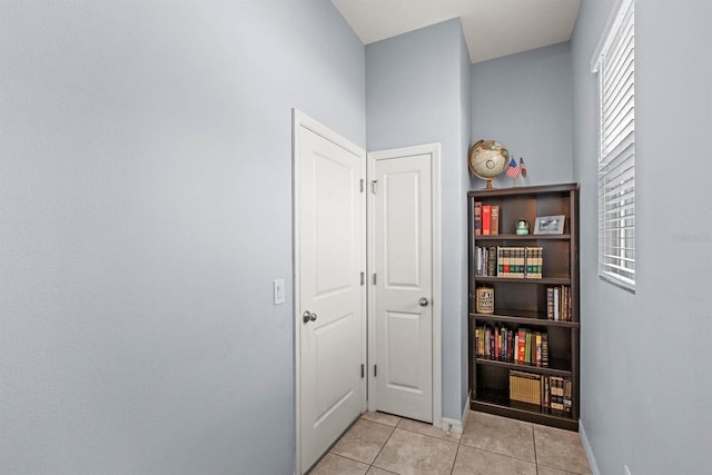 corridor featuring light tile patterned floors