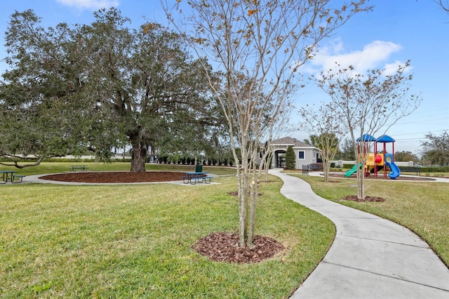 surrounding community with a playground and a lawn