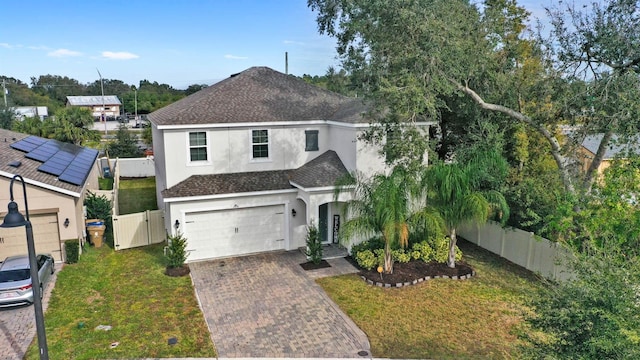 view of front of property with a front lawn and a garage