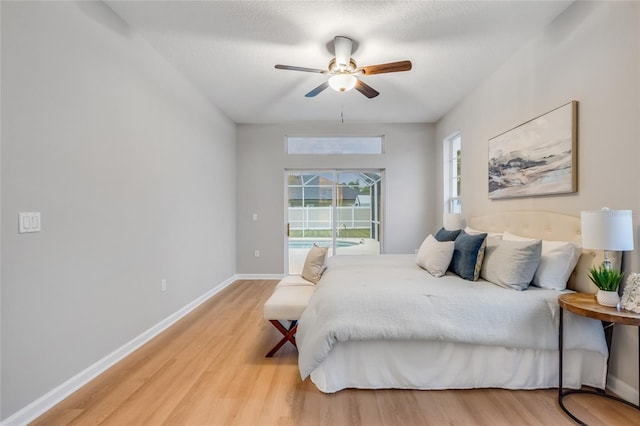 bedroom with ceiling fan, a textured ceiling, and hardwood / wood-style flooring