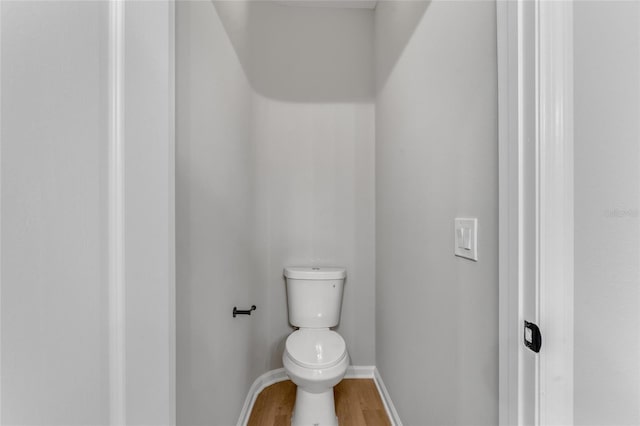 bathroom featuring hardwood / wood-style floors and toilet