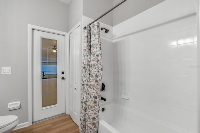 bathroom featuring toilet, shower / bath combo, and hardwood / wood-style flooring