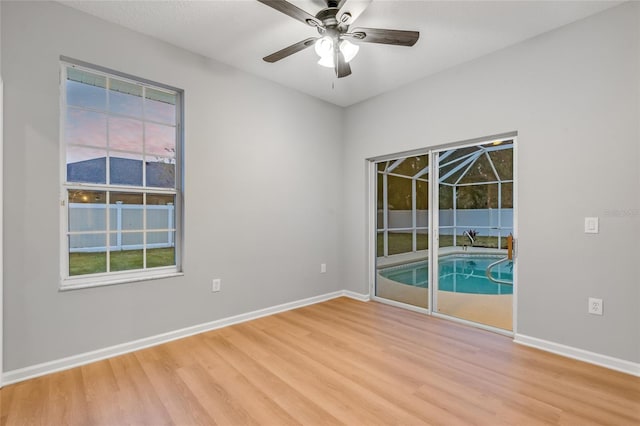 unfurnished room with ceiling fan and hardwood / wood-style floors