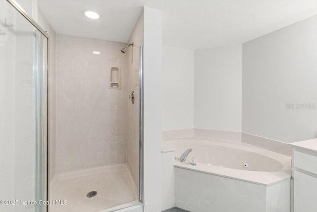 bathroom featuring vanity and separate shower and tub