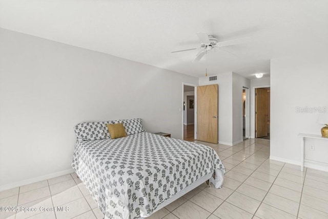 tiled bedroom featuring ceiling fan