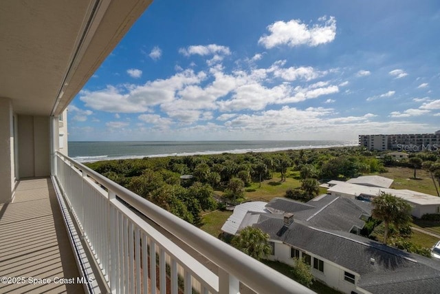 balcony with a beach view and a water view