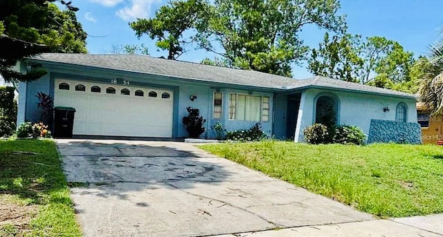 ranch-style house featuring a garage and a front yard