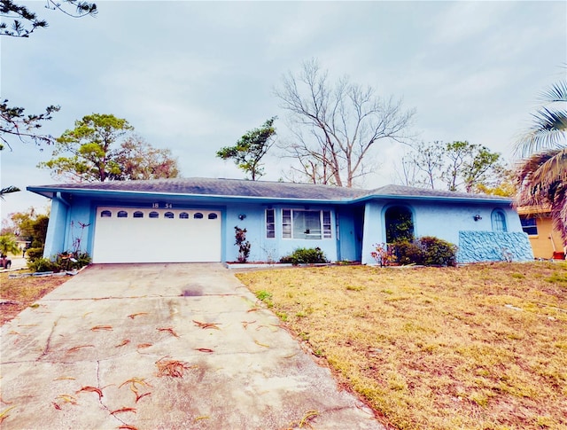 single story home with a front yard and a garage