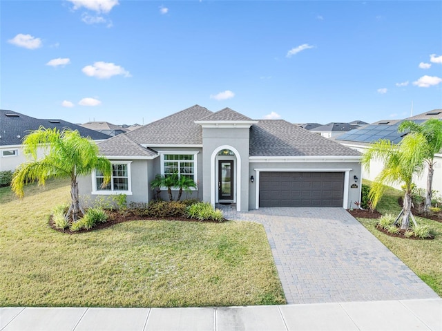 view of front of property with a front yard and a garage