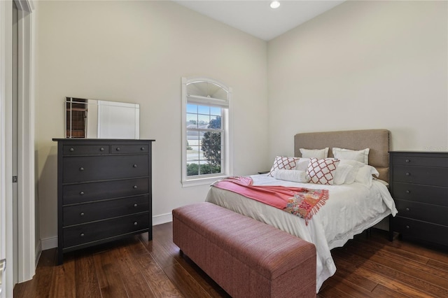 bedroom featuring dark wood-type flooring and baseboards