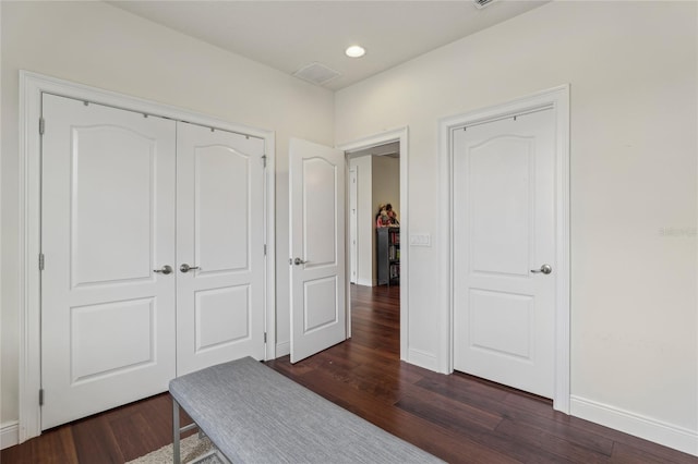 bedroom with dark wood-type flooring, recessed lighting, a closet, and baseboards