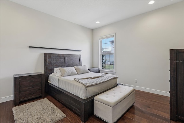 bedroom with baseboards, dark wood-style flooring, and recessed lighting