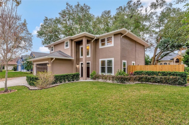 view of front of property featuring a front yard and a garage