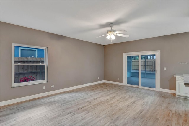 spare room featuring ceiling fan and light hardwood / wood-style floors