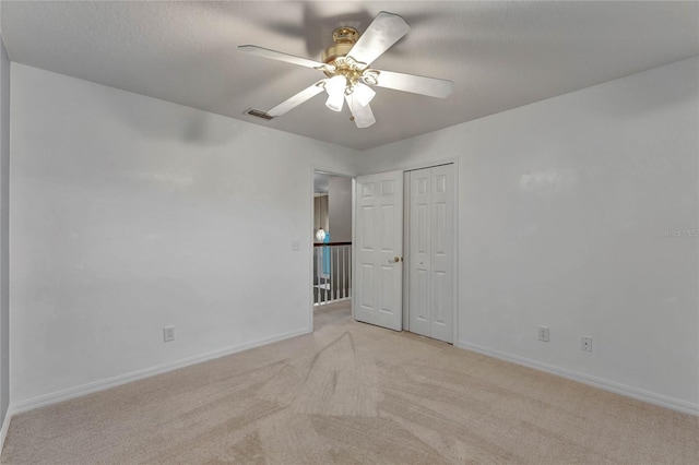 carpeted empty room with ceiling fan