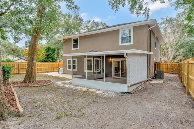 back of house featuring a sunroom and central AC unit